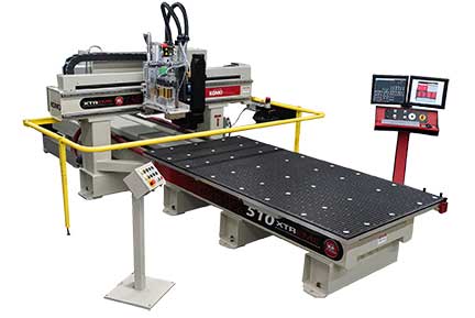 Komo Xtreme XL CNC router, quarter view showing guard rail, phenolic table, and dual monitor